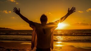 Person with hands raised out with sun in background, praising the lord.